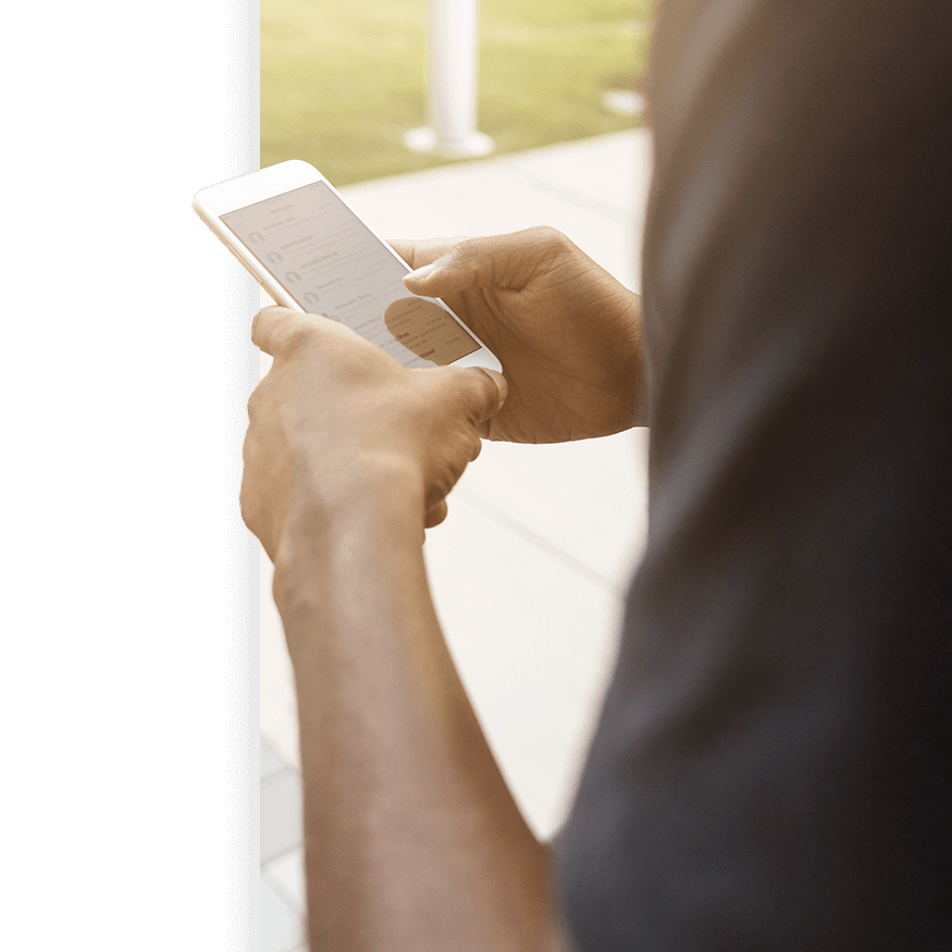 A person can be seen searching their contacts folder on their smart mobile device